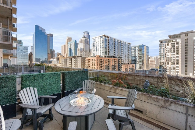 balcony with a view of skyline and a patio area