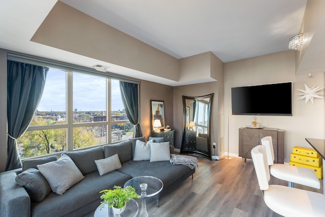 living room featuring wood finished floors, plenty of natural light, and baseboards