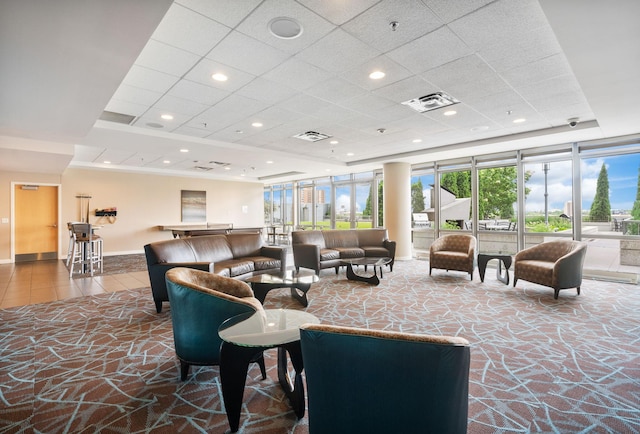building lobby featuring a drop ceiling and recessed lighting