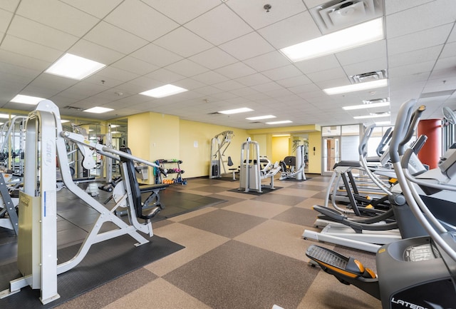 gym with a paneled ceiling