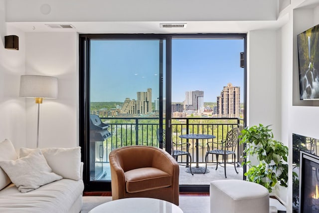 living area featuring plenty of natural light, expansive windows, and wood finished floors