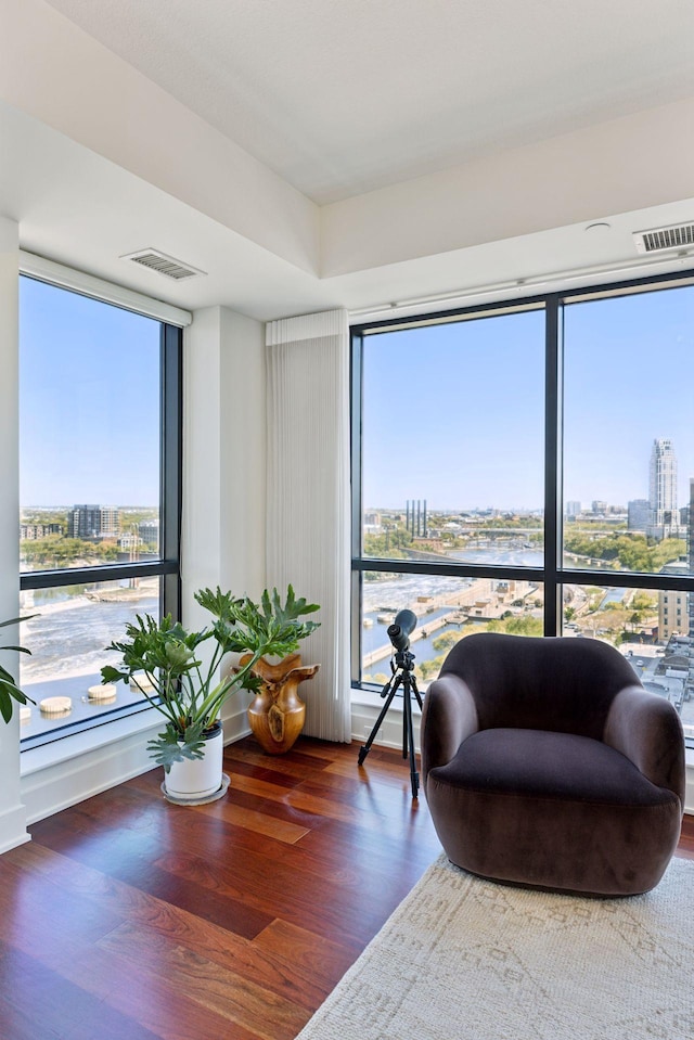 sitting room with a city view and wood finished floors