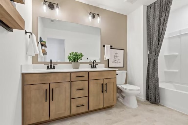 bathroom with toilet, double vanity, and bathing tub / shower combination