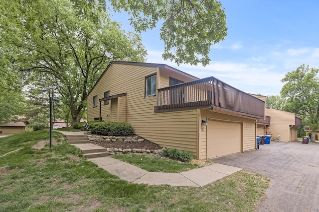 135 Eagle Lake Dr, Maple Grove, MN 55369 - view of property exterior featuring asphalt driveway, a garage, a balcony, and a lawn