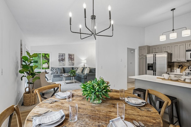 135 Eagle Lake Dr, Maple Grove, MN 55369 - dining space featuring a chandelier and high vaulted ceiling