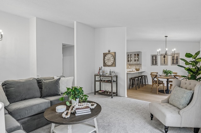 135 Eagle Lake Dr, Maple Grove, MN 55369 - living room featuring a chandelier, vaulted ceiling, and light carpet