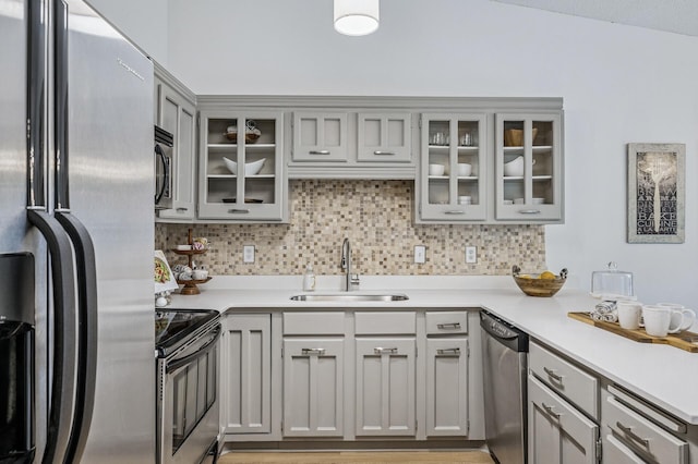 135 Eagle Lake Dr, Maple Grove, MN 55369 - kitchen with stainless steel appliances, a sink, gray cabinets, and decorative backsplash