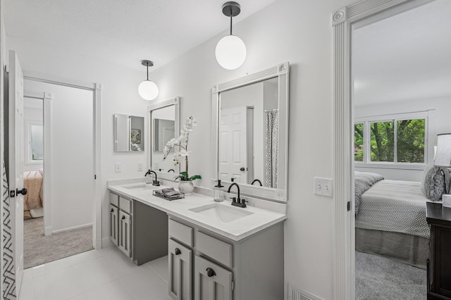 135 Eagle Lake Dr, Maple Grove, MN 55369 - bathroom with ensuite bathroom, double vanity, baseboards, and tile patterned flooring