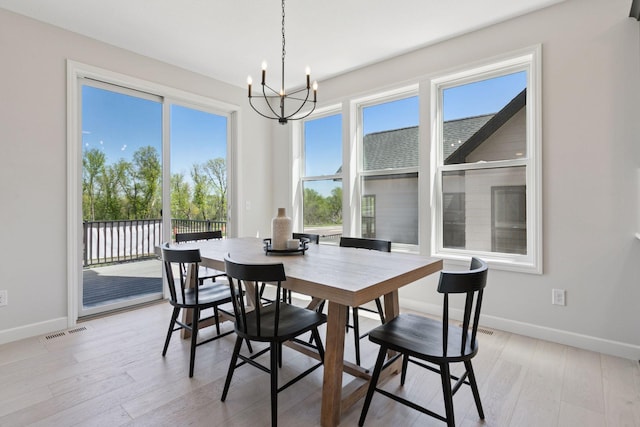 18531 Ifton Way, Lakeville, MN 55044 - dining space with a chandelier, baseboards, and light wood-type flooring