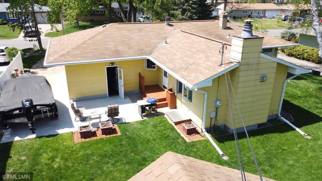2828 Matilda St, Roseville, MN 55113 - back of property featuring a chimney, a patio, and a lawn