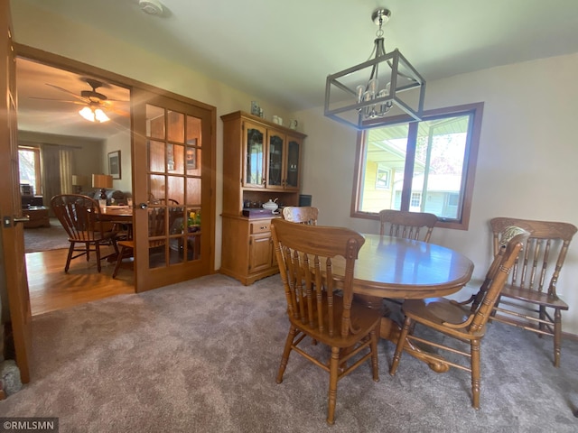 2828 Matilda St, Roseville, MN 55113 - carpeted dining space with a chandelier and ceiling fan