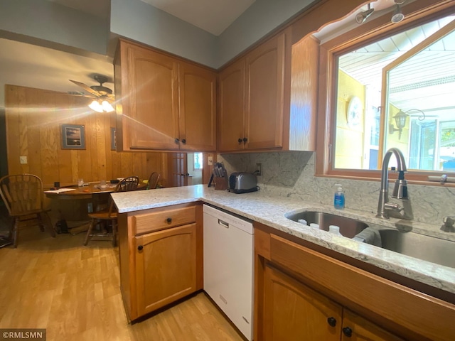 2828 Matilda St, Roseville, MN 55113 - kitchen with dishwasher, a sink, light stone counters, light wood-type flooring, and a ceiling fan