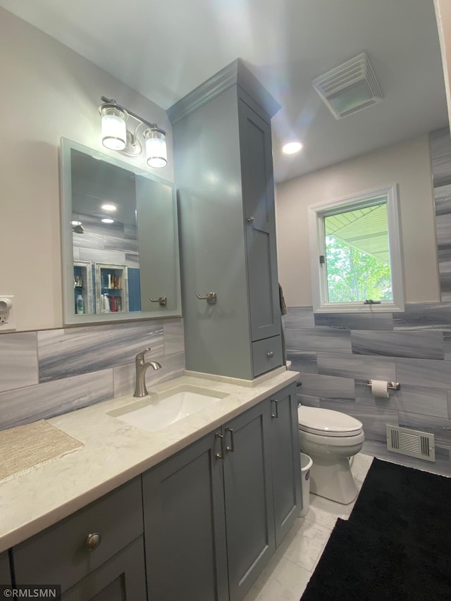 2828 Matilda St, Roseville, MN 55113 - bathroom featuring toilet, tile walls, and vanity