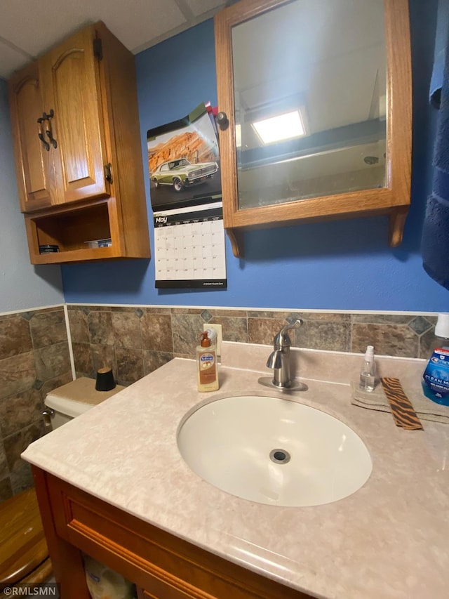 2828 Matilda St, Roseville, MN 55113 - bathroom with vanity, tile walls, and a wainscoted wall