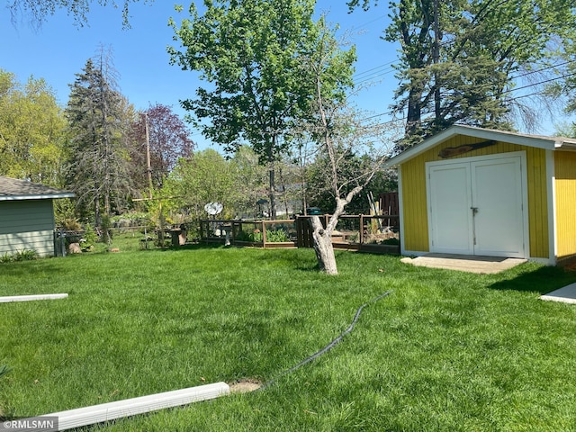 2828 Matilda St, Roseville, MN 55113 - view of yard featuring a storage unit and an outbuilding