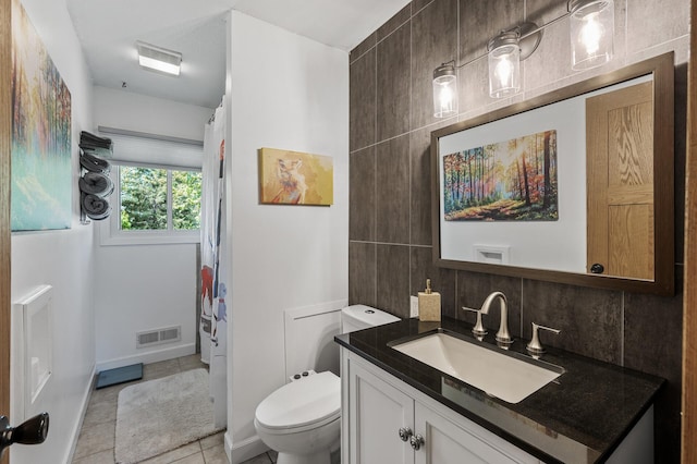 bathroom with decorative backsplash, toilet, vanity, tile patterned flooring, and curtained shower