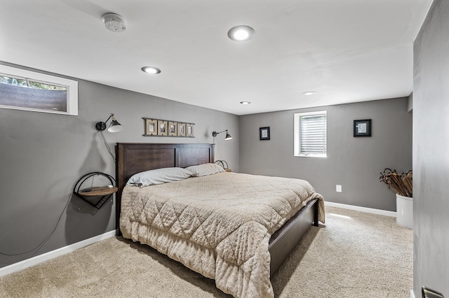 carpeted bedroom featuring baseboards and recessed lighting