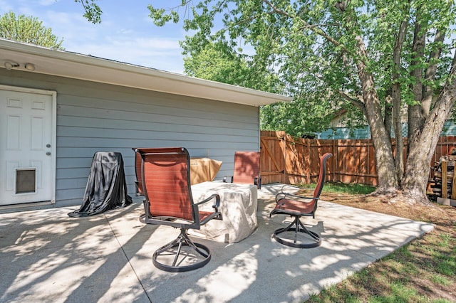 view of patio featuring fence