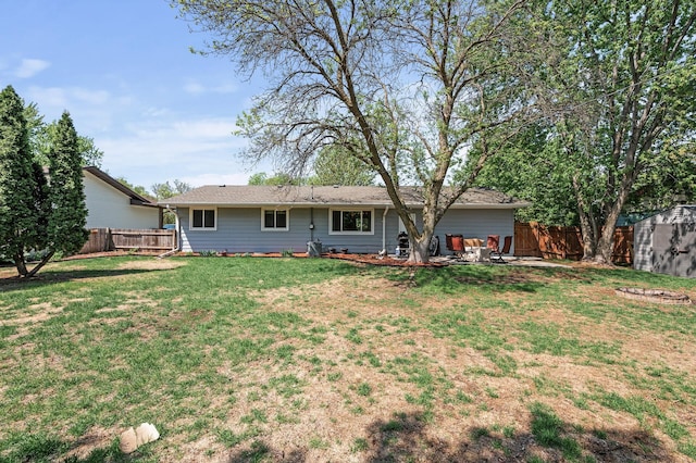 rear view of property featuring a shed, an outdoor structure, and a patio