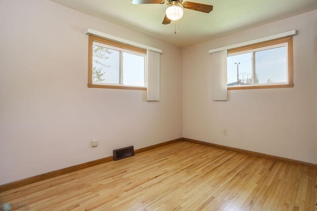 empty room with light wood-type flooring, baseboards, and a ceiling fan