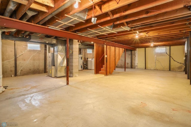 basement with water heater, stairs, and heating unit