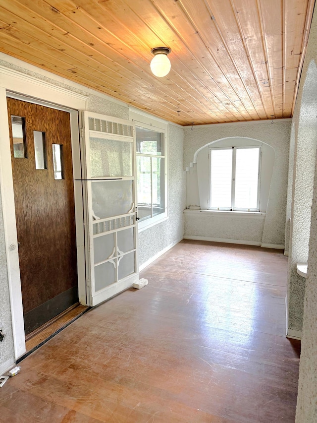 455 3rd St SE, Cokato, MN 55321 - empty room with wood ceiling, a textured wall, wood finished floors, and arched walkways