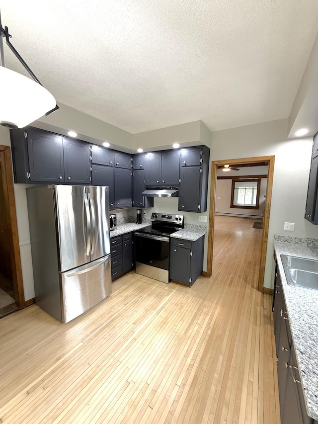 455 3rd St SE, Cokato, MN 55321 - kitchen featuring stainless steel appliances, under cabinet range hood, light wood-style flooring, and a textured ceiling