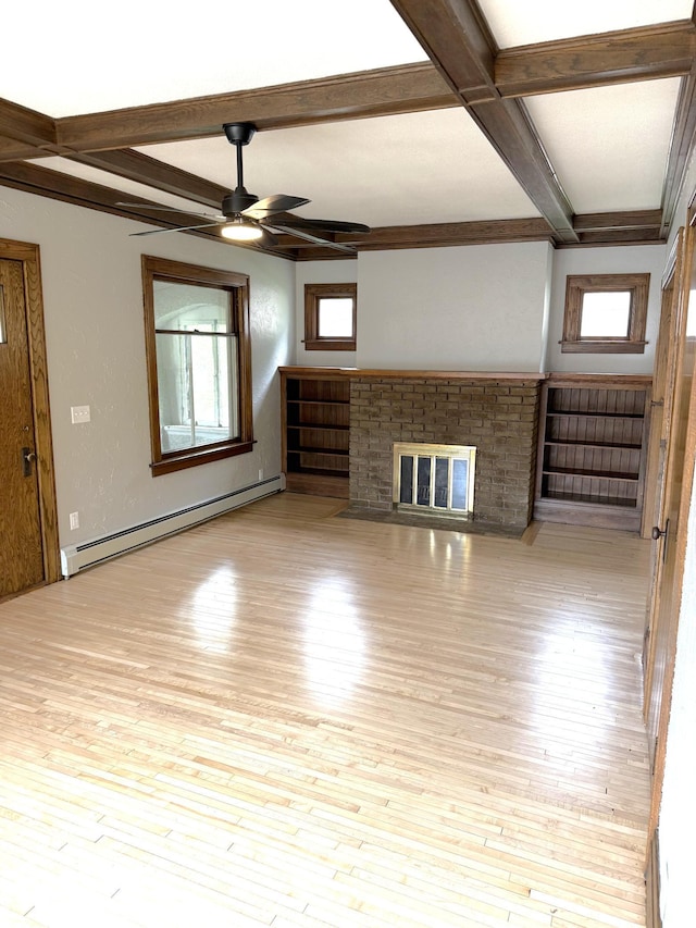 455 3rd St SE, Cokato, MN 55321 - unfurnished living room featuring a baseboard heating unit, a ceiling fan, beamed ceiling, a fireplace, and wood finished floors