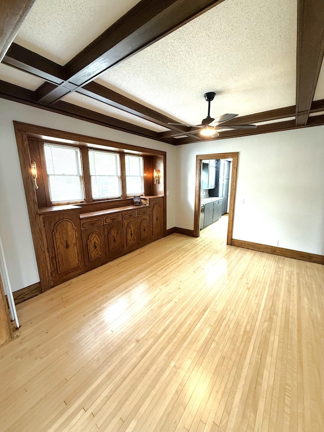 455 3rd St SE, Cokato, MN 55321 - spare room featuring a ceiling fan, beamed ceiling, a textured ceiling, light wood-style flooring, and coffered ceiling