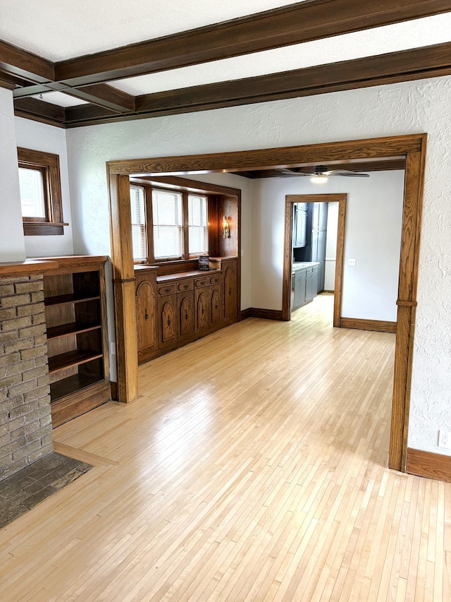 455 3rd St SE, Cokato, MN 55321 - unfurnished living room featuring beam ceiling, wood finished floors, and a textured wall