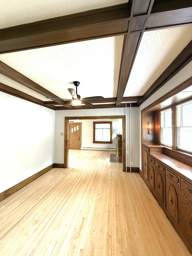 455 3rd St SE, Cokato, MN 55321 - unfurnished living room with ceiling fan, beam ceiling, and light wood-style flooring