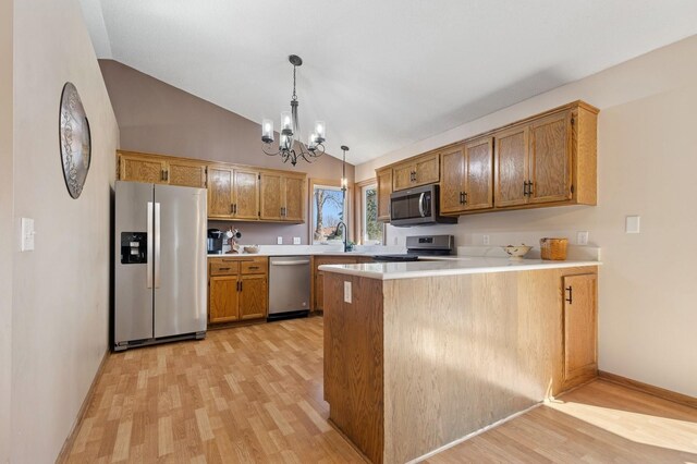 1284 Otter Ridge Rd, White Bear Twp, MN 55110 - kitchen with appliances with stainless steel finishes, a peninsula, vaulted ceiling, light wood-style flooring, and a chandelier