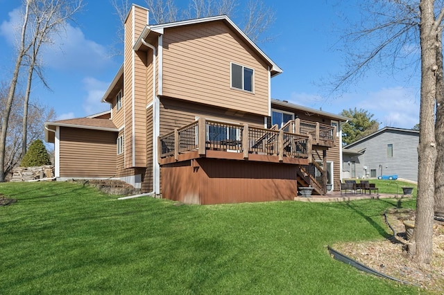 1284 Otter Ridge Rd, White Bear Twp, MN 55110 - back of house featuring a chimney, a deck, stairs, and a lawn