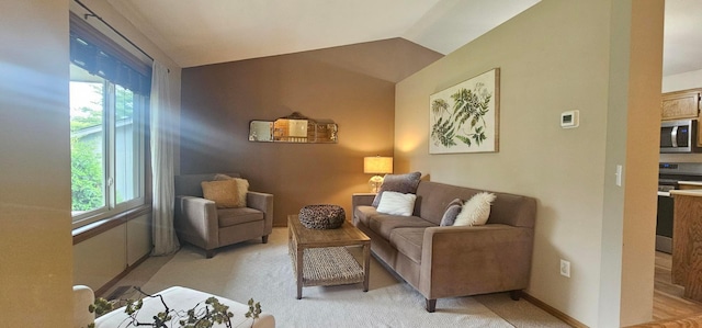 1284 Otter Ridge Rd, White Bear Twp, MN 55110 - living area featuring healthy amount of natural light, lofted ceiling, light colored carpet, and baseboards