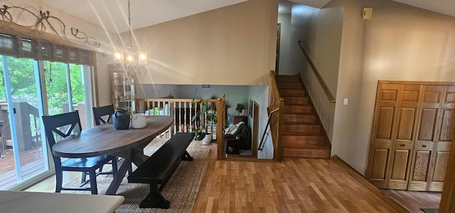 1284 Otter Ridge Rd, White Bear Twp, MN 55110 - dining area featuring a chandelier, wood finished floors, stairway, and vaulted ceiling