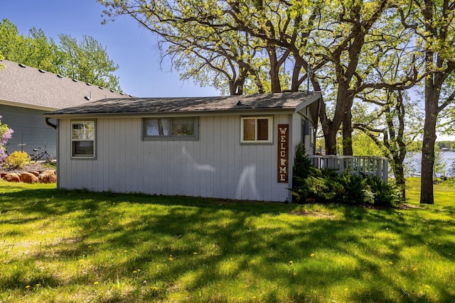 view of property exterior featuring a lawn and a deck
