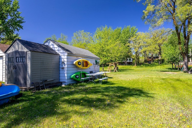 view of grassy yard with a shed and an outdoor structure