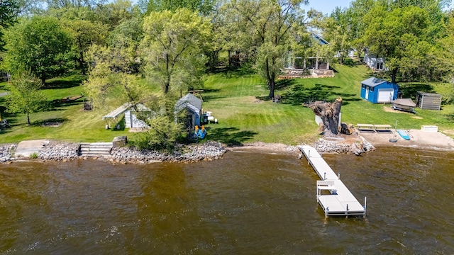 view of subject property with a nearby body of water and a tree filled landscape
