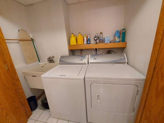 laundry area featuring washing machine and dryer and light tile patterned floors