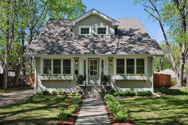 view of front facade with stucco siding and a shingled roof