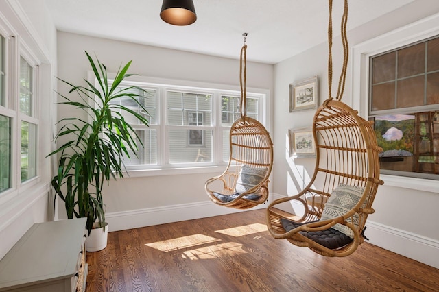 living area with wood finished floors and baseboards