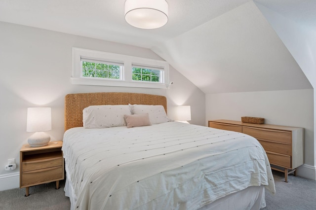 carpeted bedroom with vaulted ceiling