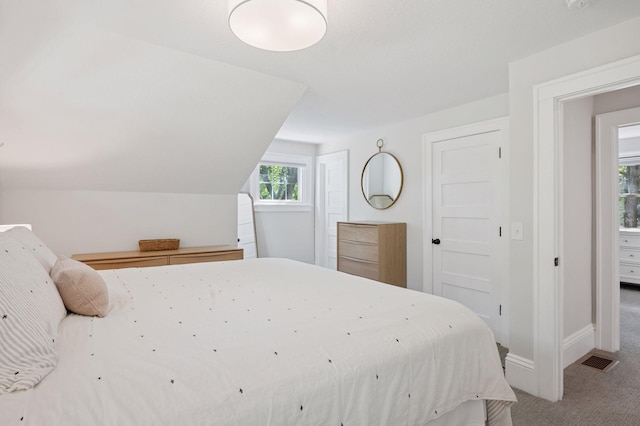 carpeted bedroom featuring baseboards