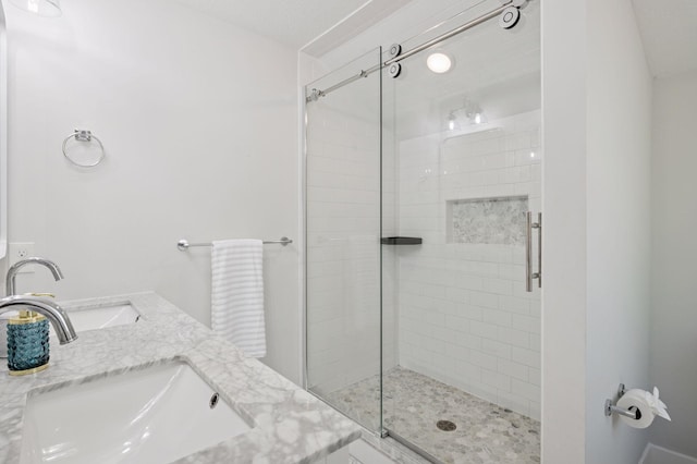 bathroom featuring a sink and a stall shower