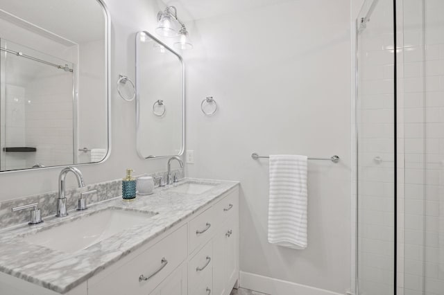 full bathroom with double vanity and baseboards