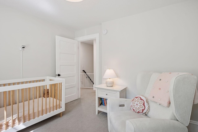 carpeted bedroom with a crib