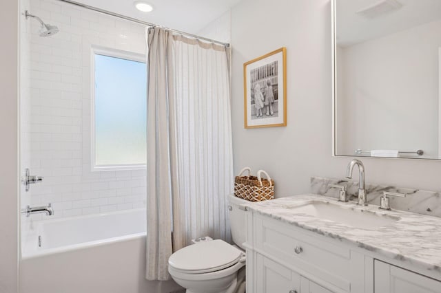 bathroom featuring toilet, shower / tub combo with curtain, and vanity