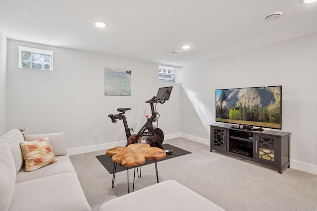 carpeted living area with plenty of natural light, recessed lighting, and baseboards