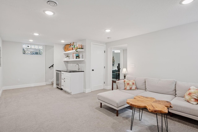 living area with recessed lighting, bar area, light colored carpet, beverage cooler, and baseboards