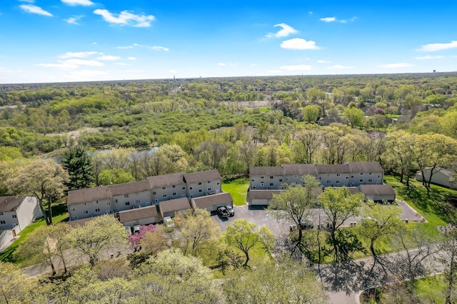 view of property location with a forest